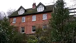 four-bay red-brick two-storey house with roof dormers