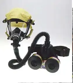 A powered air-purifying respirator with a belt-pack filter-blower that feeds air to the elastomeric mask.