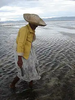 Person walking through ankle-deep waters