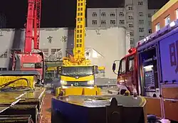 Several rescue vehicles surrounding Qiqihar school's gynasium during the night