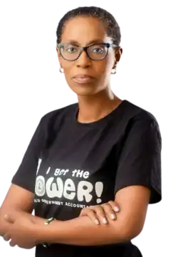 photograph of woman with short hair and glasses, crossed arms