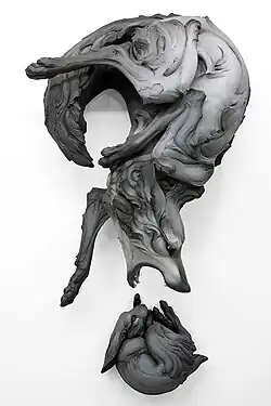Title: "The Question That Devours" Year: 2012 Dimensions: H 64 x W 35 x D 25 in. Materials: Stoneware, paint Installation: Wall Piece