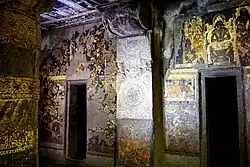Cave 2 fresco above the right door shows Buddha in Tushita heaven[133]