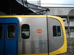 A single-arm pantograph above the driving car of the 1200 class