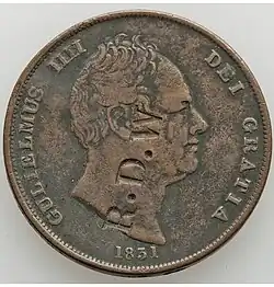 Copper coin with a man's head and letters stamped on it