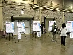 Several posters are shown in a public meeting held for the Red and Purple Modernization Project.