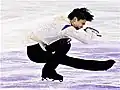 Deep sit spin with stretched free leg (Yuzuru Hanyu)