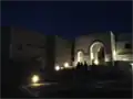 Night-time view from lower courtyard toward main chapel and upper courtyard entrance.