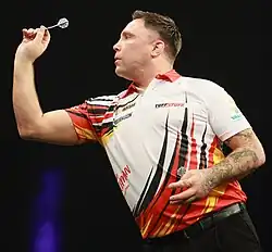 Gerwyn Price throwing a dart at a 2025 Premier League Darts event