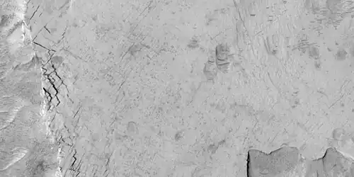 Close-up of blocks being formed, as seen by HiRISE under HiWish program. Many long fractures are visible on the surface.
