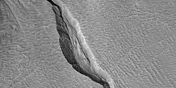 Close view of channel in gully showing streamlined forms, as seen by HiRISE under HiWish program