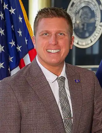 Official portrait of Corey Mock, taken in front of the North Dakota State Seal in Memorial Hall within the North Dakota State Capitol building. Photo taken in 2025.