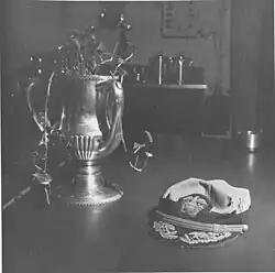 Black and white photograph of a cap placed on a table