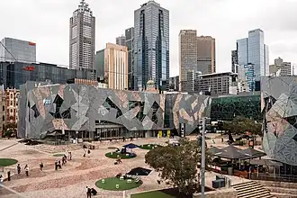 An aerial view of dark buildings in a public square.