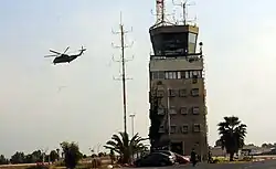 ATC Tower at Tel Nof Airbase with a CH-53D Sea Stallion Yas'ur helicopter flying by