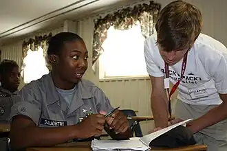 Youth ChalleNGe cadet Triana Daughtry of Augusta reviews her writing with "A Backpack Journalist" instructor Dillon Horne during a free-verse poetry course.