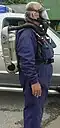 Man in boilersuit wearing a SEFA, seen from the side