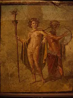 Painting of two people - the figure on the left holds a staff, while the one on the right plays a tambourine.