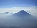 Volcán de Agua exhibits the steep cone shape typical of stratovolcanoes; as seen from Acatenango's Pico Mayor.