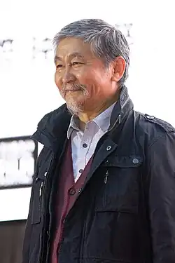 Aktan Arym Kubat at press event in three-quarter profile, smiling