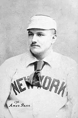 A baseball player is seen from his chest up, facing slightly left of the camera.