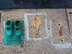 One scultpure of a pair of shoes and two blank spaces.