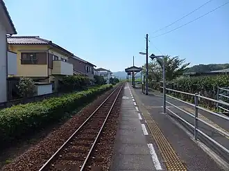 A view of the station platform and track. The ramp from the station building can be seen on the right.