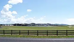 View of Ardmore Airport and surrounding farmland, backed by the Hunua Ranges.