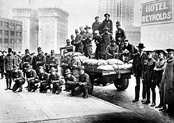 B&W photo of police and soldiers with a machine gun