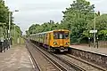 A Merseyrail Class 507 arrives with a service from Liverpool.