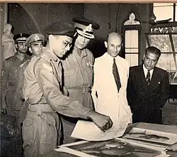 Menon shows General Cariappa and army officials his artwork at an exhibition (1951)