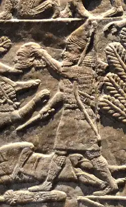 Assyrian warrior holding the head of Elamite King Teumman.[6]