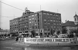 A public square with a rectangular building in the background