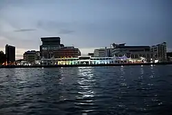The Brunei Energy Hub and wharf seem from the Brunei River at dusk in 2023