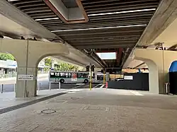 Underneath a concrete bridge with a road and construction site underneath