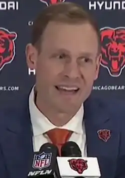 Jim Schwartz from about the waist up in a Tennessee Titans sweater and sunglasses.