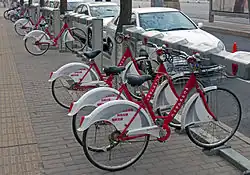 A rack of red-and-white bicycles, locked into place