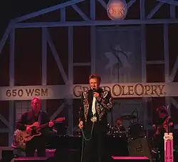 Country music singer Bill Anderson, singing on the stage of the Grand Ole Opry