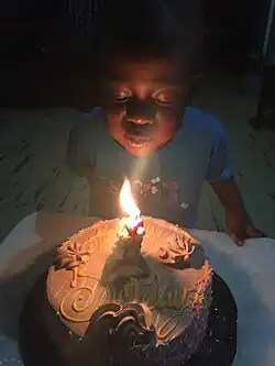 A boy blowing out his candle