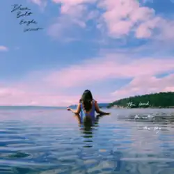 Katherine Paul standing in waist-high water with her back turned to the viewer