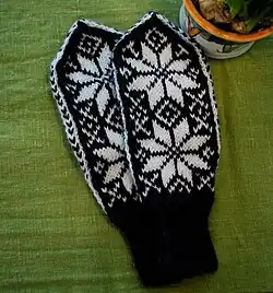 A pair of black and white Norwegian mittens