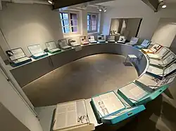 One of the exhibition rooms at Bullenhuser Damm Memorial presenting biographies in colourful suitcases