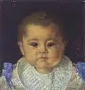 Head and shoulders portrait of an infant boy wearing a white bib
