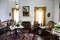 Photograph of the interior of the Bronson–Mulholland House standing in the upstairs bentwood parlor.