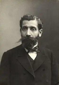Portrait photograph of Paul Brousse, wearing a suit and a long dark beard