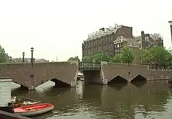 The Waalseiland bridge (bridge no. 283), designed by Joan van der Mey, in the Amsterdam School style, with the Scheepvaarthuis in the background.[1]