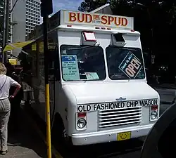 Front of white food truck with sign