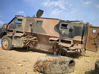 A Bushmaster IMV after encountering an IED; the drive train and utility bins were destroyed, but the hull is intact and the crew survived with only minor injuries.