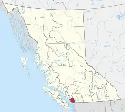 A map of British Columbia depicting its 29 regional districts and equivalent municipalities. One is highlighted in red.