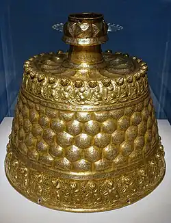 Candlestick. Brass inlaid with copper, silver, and black organic material. Seljuk period, c. 1150-1200.